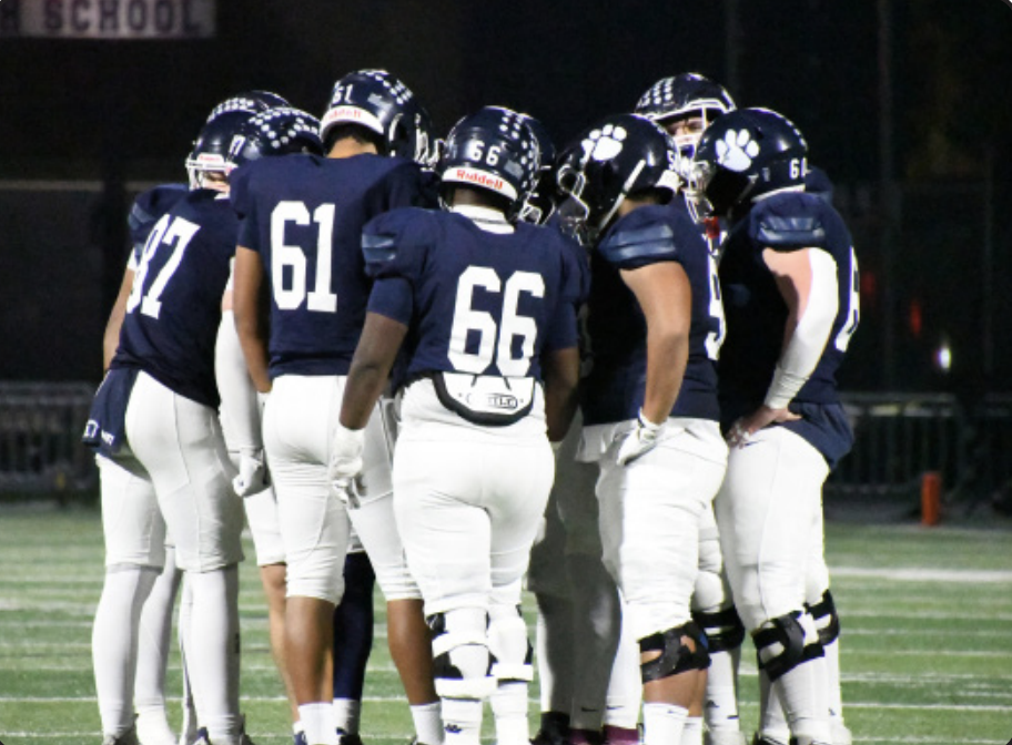 THE BIGGEST CUBS OF ALL: varsity linemen huddle before calling a big play